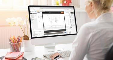 Una persona alla scrivania utilizza il software TiSystem 8 su un computer per visualizzare uno schema di circuito elettronico.